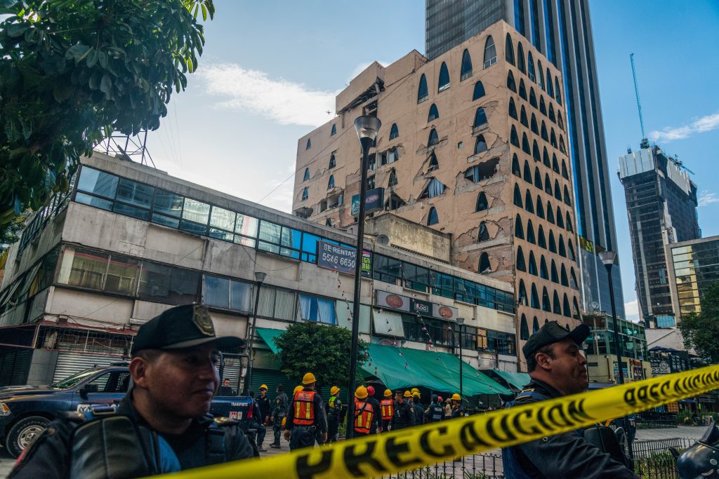 Cops restrict access to damaged office buildings and retail area.